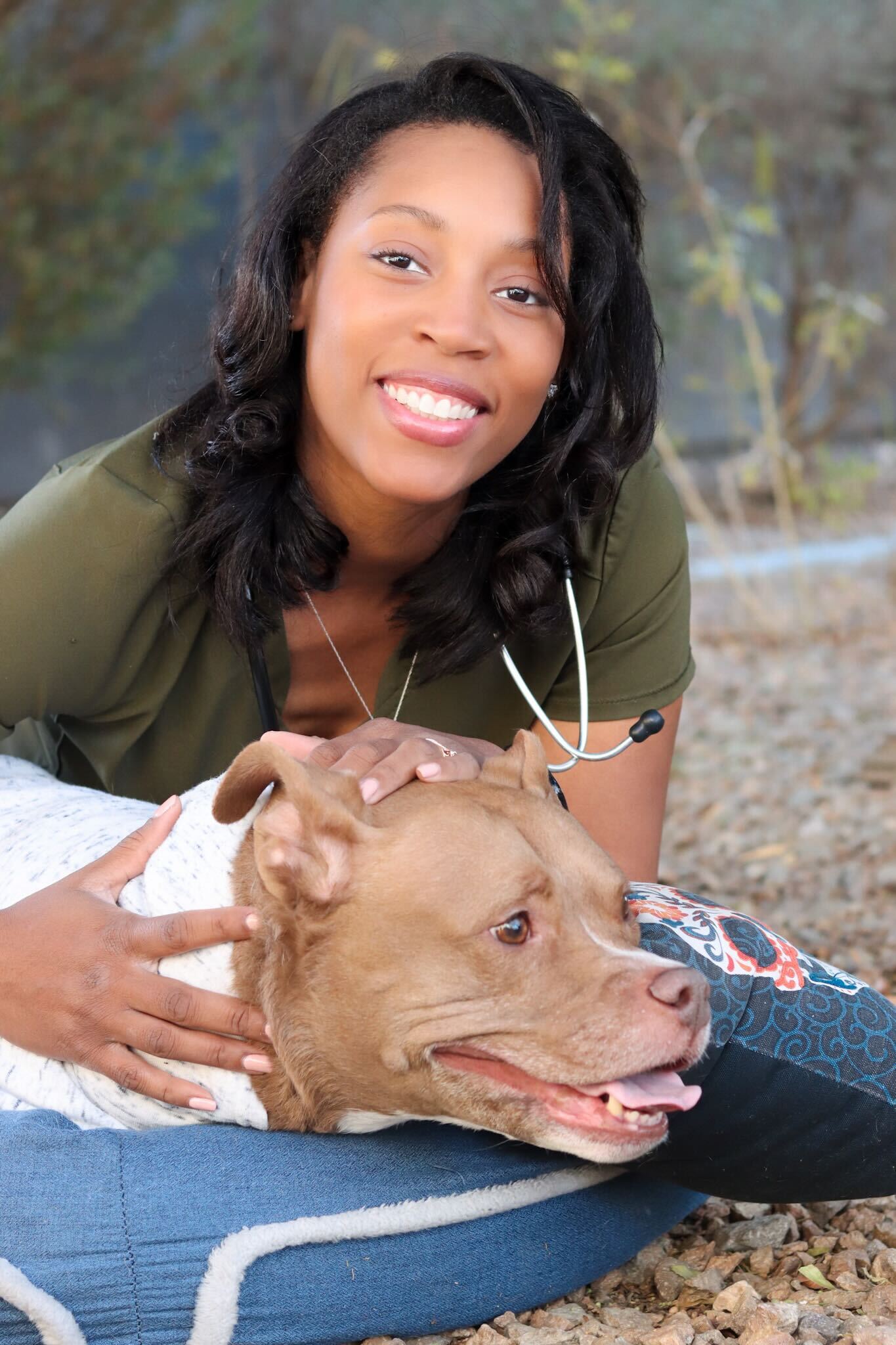 Dr. Jovanna Canty examines Gracie, a sweet dog born without front legs, during an in-home wellness visit in Las Vegas.